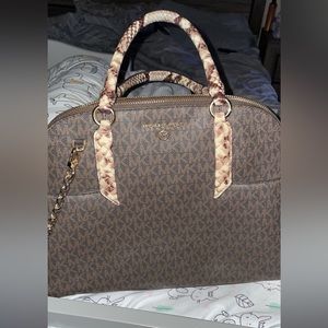 MK logo with snake skin handle